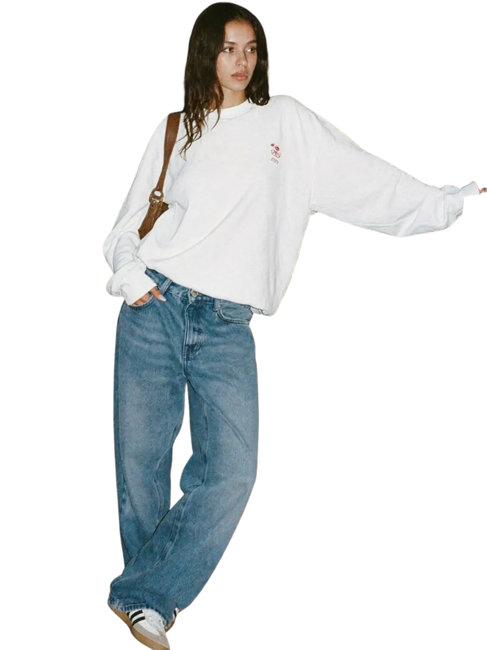 Model in a white oversized sweatshirt and relaxed denim jeans